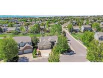 Expansive aerial view of a suburban home surrounded by mature trees in a peaceful neighborhood at 20591 E Weaver Ave, Aurora, CO 80016