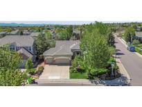 Charming ranch home with well-manicured lawn, two-car garage, and mature trees in a suburban neighborhood at 20591 E Weaver Ave, Aurora, CO 80016