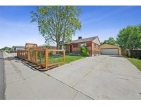 Charming brick home featuring a spacious driveway and well-maintained landscaping at 7820 Tejon St, Denver, CO 80221