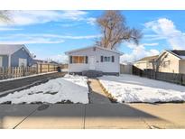 Cute bungalow home with snow covered front yard and driveway at 537 S 2Nd Ave, Brighton, CO 80601