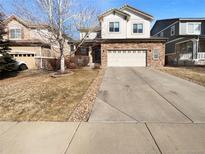 Charming two-story home boasts a well-manicured lawn, concrete driveway, and a convenient two-car garage at 24963 E Hoover Pl, Aurora, CO 80016