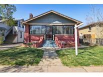 Charming brick bungalow with a landscaped front yard and inviting entryway stairs at 3527 W 44Th Ave, Denver, CO 80211