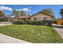 Charming ranch-style home featuring a well-maintained lawn and inviting curb appeal at 6436 Otis St, Arvada, CO 80003