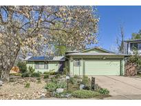 Charming single-Gathering home featuring a well-maintained lawn and a two-car garage at 547 S Flower St, Lakewood, CO 80226