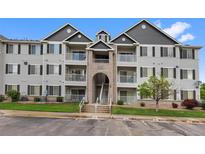 Exterior of a three-story condominium building with brick and siding and walkways to unit doors and balconies at 15700 E Jamison Dr # 3-307, Englewood, CO 80112