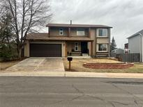 Charming two-story home with a well-maintained front yard and attached two-car garage at 18438 E Berry Dr, Centennial, CO 80015