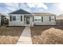 Ranch style home with gray siding, blue trim, and a well-maintained lawn at 1716 Moline St, Aurora, CO 80010