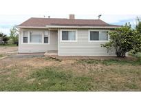 A charming single-story home featuring a well-kept lawn, tidy siding, and traditional windows for a welcoming curb appeal at 437 S Fetzer St, Byers, CO 80103
