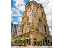 Stylish building with an impressive tan brick design under a bright blue sky with fluffy white clouds at 300 W 11Th Ave # 18C, Denver, CO 80204