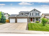 Charming two-story home with a three car garage, covered porch and landscaped front yard at 12000 Horseshoe Ln, Parker, CO 80138