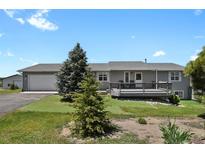 Charming single-story home with a spacious front yard and a lovely wood deck at 3596 Longs Peak Cir, Parker, CO 80138