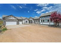 Charming home featuring stone accents, inviting curb appeal, and a spacious driveway at 3794 N State Highway 67, Sedalia, CO 80135