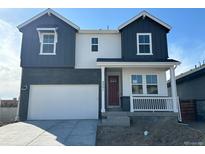 Charming two-story home featuring a brick facade, covered porch, and a two-car garage at 3351 N Buchanan Way, Aurora, CO 80019