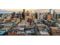 An aerial view of a bustling cityscape at sunset showing numerous skyscrapers in a dense urban environment at 1750 Wewatta St # 830, Denver, CO 80202