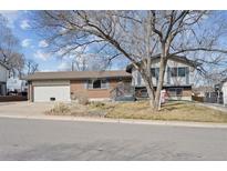 Charming single Gathering home with brick exterior, attached garage and mature trees in a suburban neighborhood at 10475 Tancred St, Northglenn, CO 80234