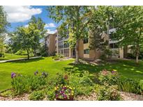 Beautifully landscaped condo complex surrounded by lush greenery, flowers, and mature trees at 3082 S Wheeling Way # 202, Aurora, CO 80014
