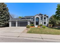 Charming two-story home with a three car garage, landscaped yard, and a modern exterior design at 9382 Lark Sparrow Dr, Highlands Ranch, CO 80126