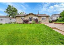 Charming single-story home with stone exterior and a well-manicured lawn in a quiet neighborhood at 3450 W Amherst Ave, Denver, CO 80236