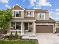 Charming two-story home with a well-manicured lawn, inviting porch, and a two-car garage at 3620 Sandoval St, Brighton, CO 80601