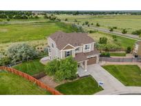 Beautiful two-story home with a well-manicured lawn and large backyard at 3620 Sandoval St, Brighton, CO 80601