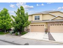 Inviting two-story home featuring a two-car garage and stone accents at 22391 E Plymouth Cir, Aurora, CO 80016