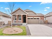 Charming single-Gathering home with a two-car garage and inviting front porch at 8552 W San Juan Ave, Littleton, CO 80128