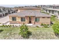 Charming single Gathering home showcasing stone accents, manicured lawn, and tasteful landscaping at 12258 Hazel Spruce Ct, Parker, CO 80134