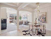 Bright living area featuring a fireplace, open floor plan, and access to an outdoor balcony at 1747 N Washington St # C306, Denver, CO 80203