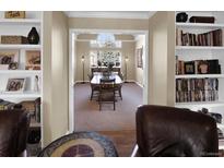 Bright dining room boasts large window, view to backyard, and attractive decor at 8978 W Brandt Dr, Littleton, CO 80123