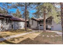 Inviting exterior of a multi-Gathering home surrounded by mature trees and manicured lawns at 2378 Hearth Dr # 6, Evergreen, CO 80439
