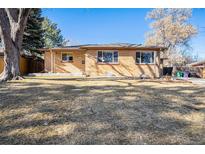 Charming brick home with large front yard and mature trees in a quiet neighborhood at 1623 S Ivy Way, Denver, CO 80224