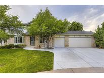 Charming two-story brick home with a well-maintained lawn, mature trees, and a spacious three-car garage at 5723 S Kittredge St, Centennial, CO 80015