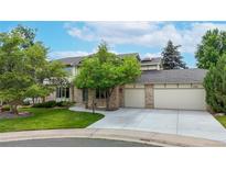 Charming two-story home with a well-manicured lawn and mature trees adding curb appeal at 5723 S Kittredge St, Centennial, CO 80015