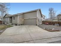 Charming home with a two car garage and a beautifully landscaped front yard at 8345 Moore St, Arvada, CO 80005