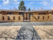 An elaborate brick facade featuring a gated entrance and meticulously designed concrete driveway at 4365 S Alton Way, Greenwood Village, CO 80111