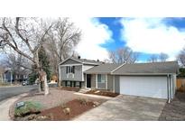 Two-story home featuring a 2-car garage and neutral colored paint at 3664 S Moore St, Denver, CO 80235