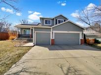 Charming two-story home with a well-maintained lawn, two car garage and solar panels at 12203 Wolff Dr, Broomfield, CO 80020