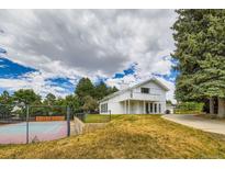 Stunning two-story home with a beautiful balcony and tennis court on expansive grounds at 6668 Walker Ct, Niwot, CO 80503