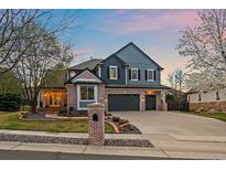 Beautiful two-story home with a well-manicured lawn, brick accents, and a spacious three-car garage at 13955 Craig Way, Broomfield, CO 80020