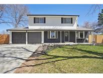 Charming two-story home with a well-manicured lawn and a two-car garage at 6087 W 84Th Ave, Arvada, CO 80003