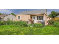 Charming single-Gathering home featuring a well-manicured lawn and lush landscaping at 6736 Grove St, Denver, CO 80221