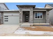 Charming single-Gathering home boasts a contemporary design with stone accents and a welcoming front porch at 8225 Cokedale Cir, Littleton, CO 80125