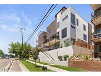 Modern townhome exterior featuring balconies, clean lines, and stylish landscaping at 2851 W 23Rd Ave # 1, Denver, CO 80211