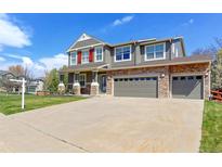 Charming two-story home featuring a stone facade, three-car garage, and well-maintained lawn at 2901 Madison Ln, Broomfield, CO 80023