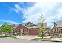 Charming single-Gathering home with a two-car garage, stone accents, and well-kept landscaping at 1130 Summit View Dr, Louisville, CO 80027