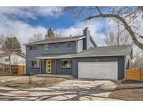 Charming two-story home with a freshly painted exterior, and bright yellow front door at 9288 W Wesley Dr, Lakewood, CO 80227