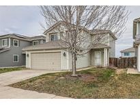 Inviting two-story home with a well-manicured lawn and a convenient two-car garage at 20785 E 39Th Ave, Denver, CO 80249