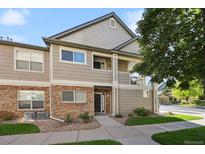 Charming two-story home featuring stone accents and neutral siding, with a well-manicured lawn and inviting walkway at 4385 S Balsam St # 3-101, Littleton, CO 80123