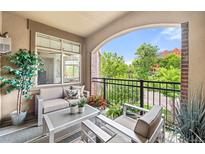 Inviting balcony features comfortable seating, an outdoor rug, and views of the surrounding neighborhood at 1100 N Grant St # 208, Denver, CO 80203