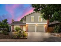 Charming two-story home with a two-car garage and lush landscaping in a suburban neighborhood at 12671 E Bates Cir, Aurora, CO 80014